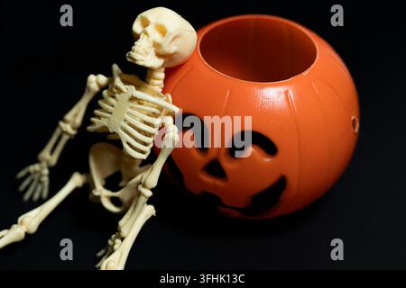 3D render close up of a small plastic skeleton skull against a dark background with copy space Stock Photo