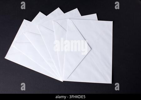 closed envelopes with white spot light on black background Stock Photo