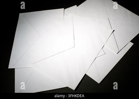 closed envelopes with white spot light on black background Stock Photo