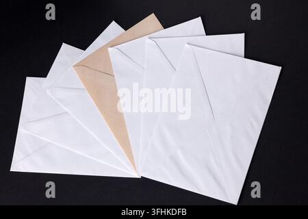 closed envelopes with white spot light on black background Stock Photo