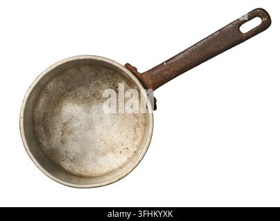old rusty metal saucepan isolated white background, scratched interior surface and weathered iron handle, top view in close-up Stock Photo