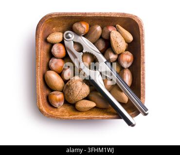 various unpeeled nuts in wooden bowl Stock Photo