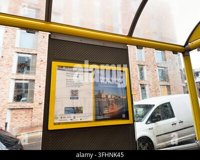 Liverpool, UK - May 16, 2026: Rain-speckled bus shelter display showing Ferry Cross the Mersey poster and service notice on a Liverpool UK street. Stock Photo