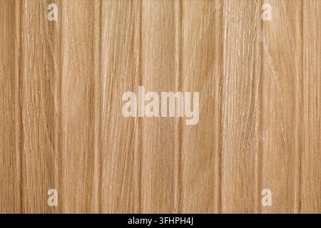 Light Brown Wood Grain Texture Background. Close-up of a light brown wooden surface with vertical grain lines, subtle tonal variation and a smooth Stock Photo