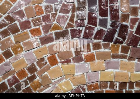 Macro of earthy brown and beige ceramic mosaic tiles with varied shapes Stock Photo
