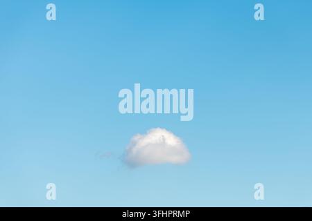 Small cloud isolated in the blue sky. Stock Photo