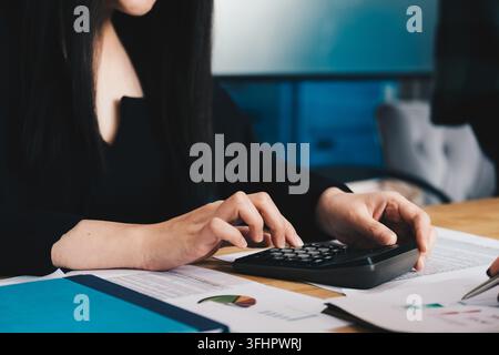 Close up of businessman or accountant hand working on calculator Stock Photo