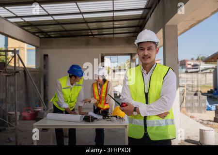 Happy of team construction worker. engineer, construction site and team outdoor for building project Stock Photo