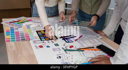 Brainstorm team of creative web graphic designer planning. Creative designers present ux ui to team. Designers team working meeting in office. Stock Photo