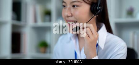 Call center woman asian in office for customer service, technical support and advice, contact and communication with employee operator in help desk ag Stock Photo