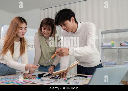 A diverse team of UX developers and UI designers collaborating and brainstorming on new project ideas in a modern office setting. Stock Photo