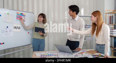 Team of UX developers and UI designers collaborating on a project, brainstorming ideas, and discussing design concepts in a modern office setting. Stock Photo