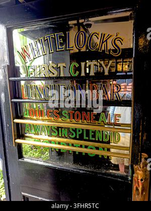 Historic Whitelock's First City Luncheon Bar door and painted glass lettering in Turk's Head Yard, Leeds. Stock Photo