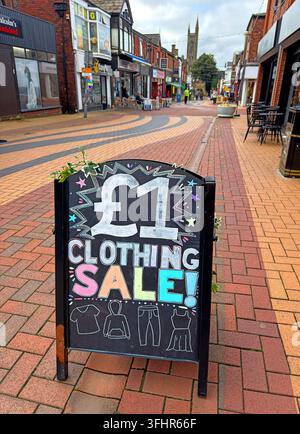£1 clothing sale pavement sign outside a discount shop on Chapel Street, Chorley, Lancs. low-cost retail, betting, vape and charity shops shape town Stock Photo
