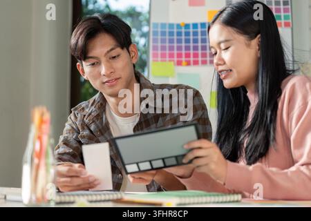 A design team collaborates on graphics blending innovative ideas and visuals in a vibrant workspace. Stock Photo