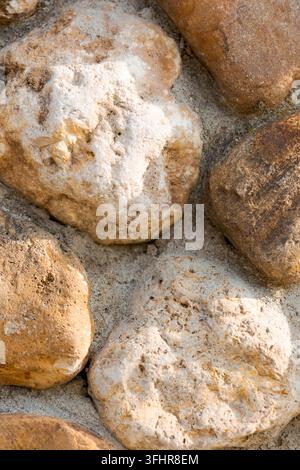 A close view of a wall made of gray bricks showing wear and signs of ...