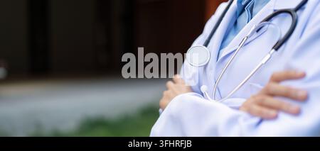 Dedicated doctor in a white coat with stethoscope, embodying healthcare professionalism. Stock Photo
