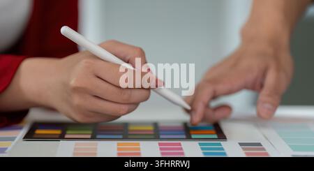 A collaborative session showcases the creative process as team members work together, refining color palettes for their project. The synergy enhances Stock Photo