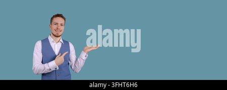 Surprised young man showing hand gesture in blank copy. Surprised man standing Stock Photo