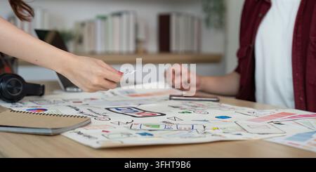 A creative team collaborates on design ideas, sharing feedback and materials in a modern workspace. Stock Photo