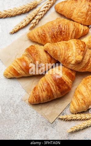 Freshly baked croissants with wheat on baking paper Stock Photo