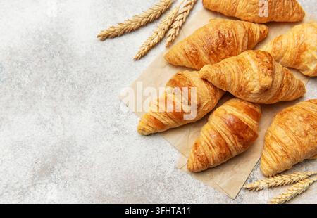 Freshly baked croissants with wheat on baking paper Stock Photo