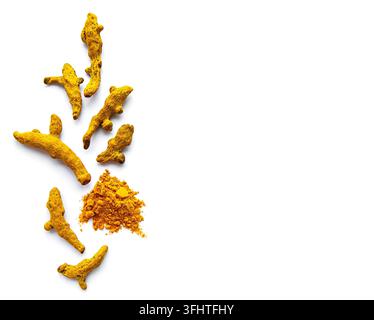 Yellow turmeric powder and dry roots on white  background. Stock Photo