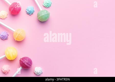 Sweet lollipops and candies on pink background Stock Photo