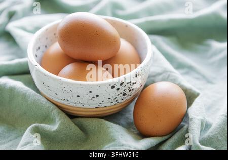 Bowl of fresh  brown eggs on concrete background Stock Photo
