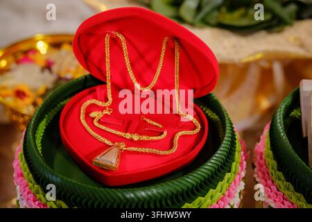 Elegant gold necklace jewelry set inside a red heart box for wedding engagement Stock Photo