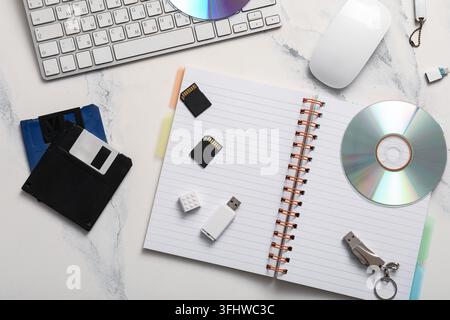Data storage evolution and digital legacy, vintage floppy disks with modern memory cards and optical media on a desk for technology history research Stock Photo
