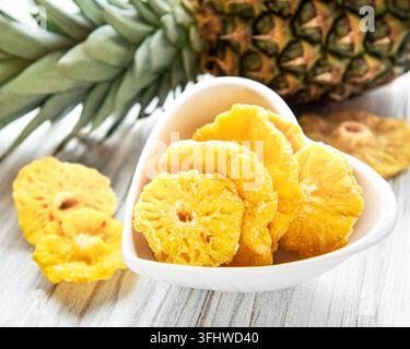 Pineapple dried rings on rustic wooden background Stock Photo