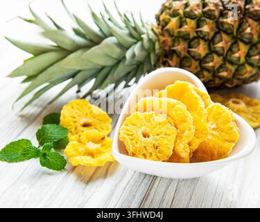 Pineapple dried rings on rustic wooden background Stock Photo