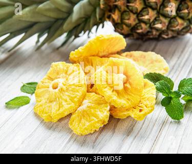 Pineapple dried rings on rustic wooden background Stock Photo