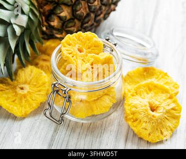 Pineapple dried rings on rustic wooden background Stock Photo