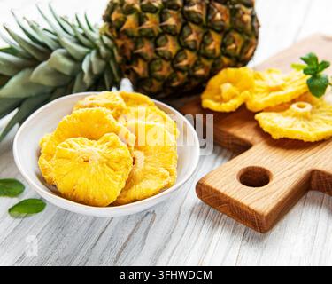 Pineapple dried rings on rustic wooden background Stock Photo