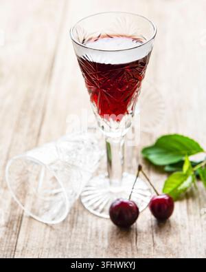 Cherry liqueur in a glass and fresh fruits Stock Photo