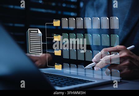 Digital document classification and records management concept. Person using laptop, sorting files into folders through workflow for archiving, organi Stock Photo