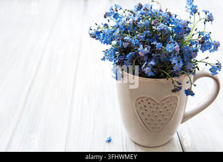 Forget me not flowers in a cup Stock Photo