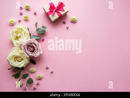 Flowers composition.  Gift boxes  and various colorful flowers on light pink  background. Flat lay, top view, copy space Stock Photo