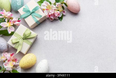 Easter gifts and speckled eggs with spring flowers Stock Photo