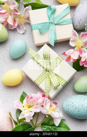 Easter eggs and gift boxes with spring flowers decorating a festive table Stock Photo