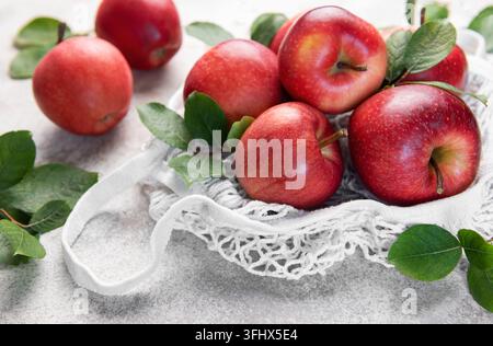 Fresh red apples resting in a reusable shopping bag Stock Photo