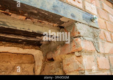 Reinforcement of a brick wall opening with steel beam and concrete support Stock Photo