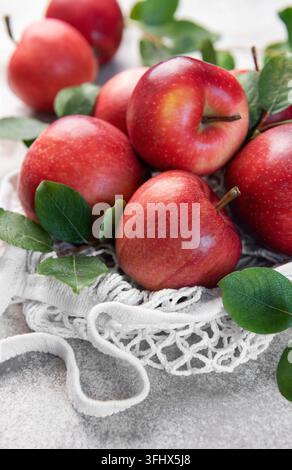 Fresh red apples resting in a reusable shopping bag Stock Photo