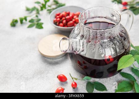 Rosehip herbal tea brewing in glass teapot Stock Photo