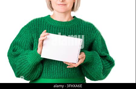 Woman holding a blank spiral notebook isolated on white background with generous copy space, presenting a clean writing and planning template Stock Photo