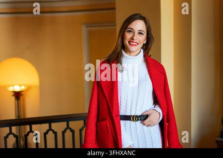 Cute girl in red coat smiling outside Stock Photo