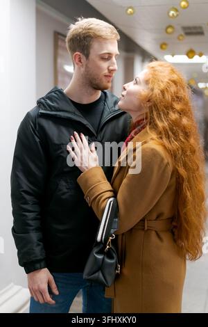 Man and a woman are standing in a hallway Stock Photo