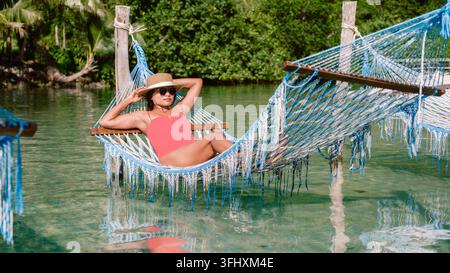 Relaxing in a hammock on the tranquil shores of Koh Kood Island Thailand Stock Photo